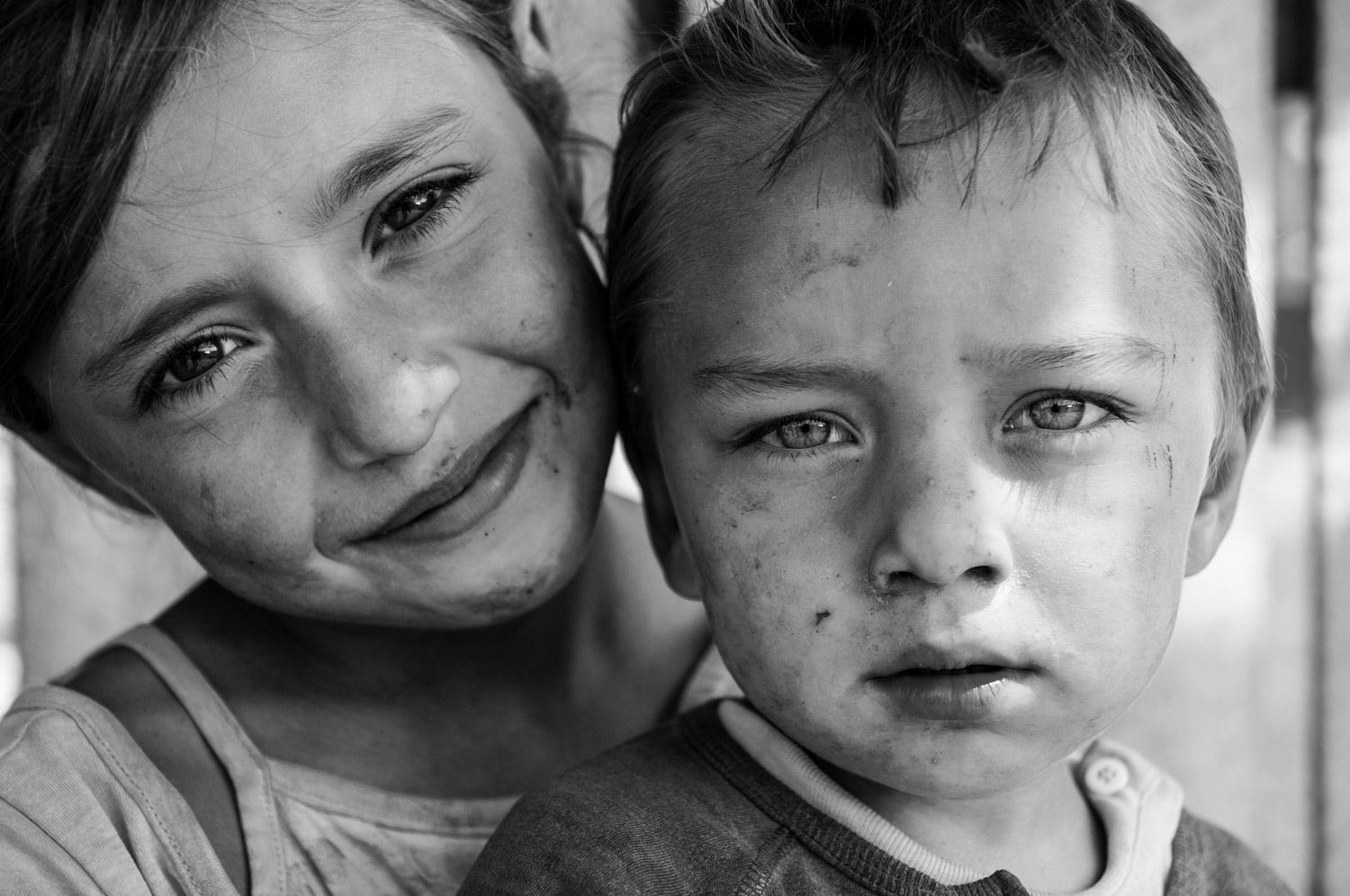 Brother and sister portrait. Black and white photo by Ellis photography. Close up of a boy and a girl with big eyes.